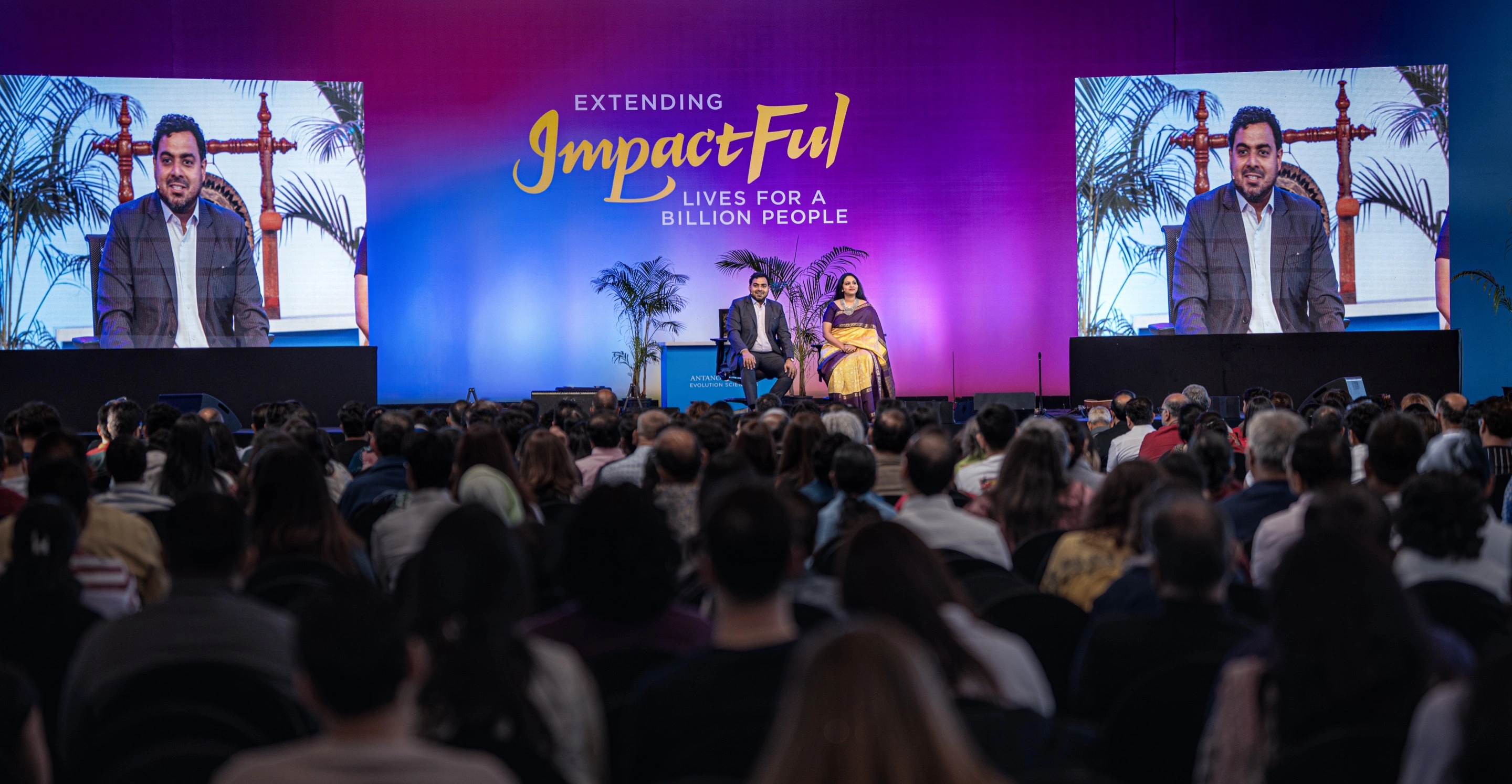 Antano and Harini on stage — Extending ImpactFul Lives for a Billion People